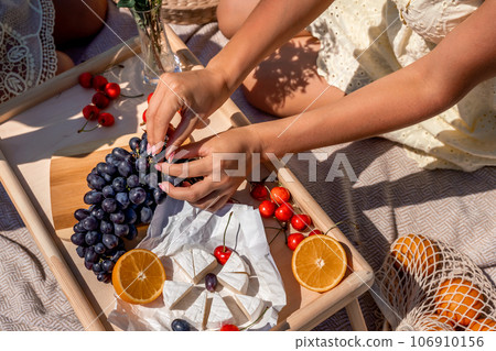 dark grapes orange slices and strawberries close up sorting through fruits dark grapes orange slices and strawberries close up sorting through fruits 106910156