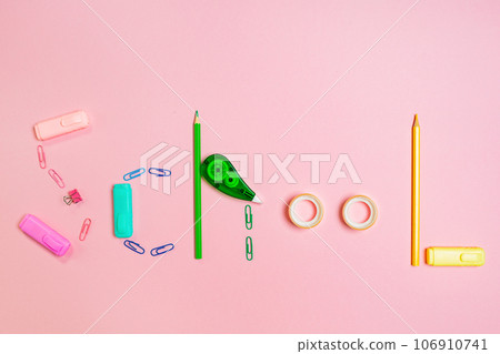 Back to school concept. The inscription is made up of multi-colored stationery. Pink background. Flat lay 106910741