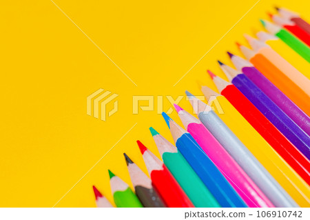 Creativity. Multicolored crayons alid in a row on yellow background. Colorful pencils. Close up. Copy space Creativity. Multicolored crayons alid in a row on yellow background. Colorful pencils. Close up. Copy space 106910742