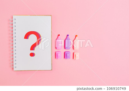 Copybook with question mark and multicolored markers on pink background. Flat lay. Concept of education and creativity Copybook with question mark and multicolored markers on pink background. Flat lay. Concept of education and creativity 106910749