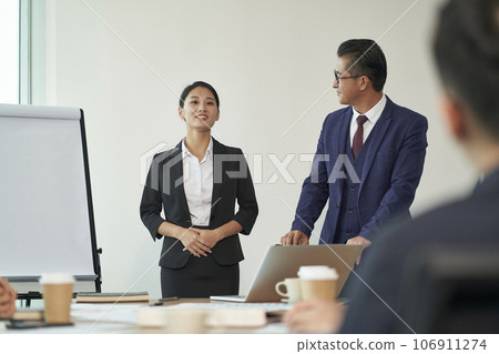 young asian new employee introduced to team by boss during staff meeting in office young asian new employee introduced to team by boss during staff meeting in office 106911274