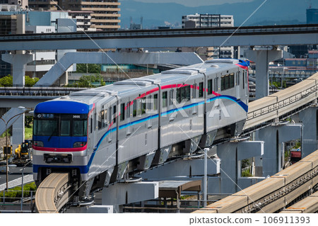 Monorail departing from Banpaku Kinen Koen Station and heading towards Saito West Monorail departing from Banpaku Kinen Koen Station and heading towards Saito West 106911393