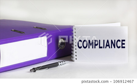 Notepad with Compliance text, on white background with folder and pen Notepad with Compliance text, on white background with folder and pen 106912467