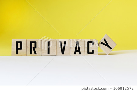 Privacy word on wooden cube and white and yellow background. Privacy word on wooden cube and white and yellow background. 106912572