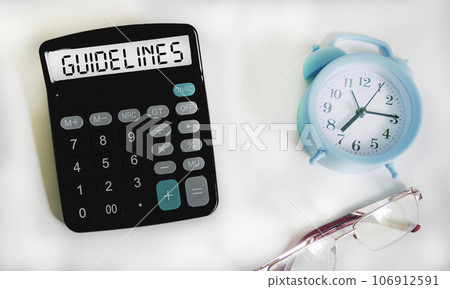 Close-up of a calculator with text recommendations on a white background 106912591