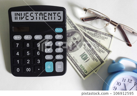 Investments word on a calculator. Business and finance concept. 106912595