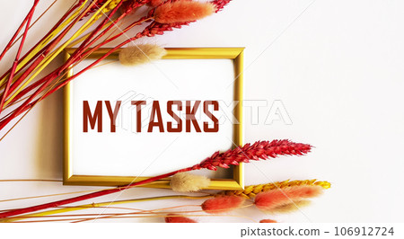 The text My tasks on a gold frame and a white background framed by colored ears of wheat The text My tasks on a gold frame and a white background framed by colored ears of wheat 106912724