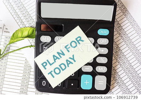 Plan for today, the text is written on a sticker, next to a calculator and financial documents Plan for today, the text is written on a sticker, next to a calculator and financial documents 106912739