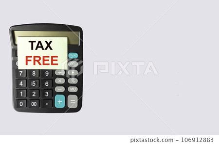 Tax Free text, written on a note that lies on a calculator and a white background. Place for text 106912883