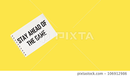 White card with the text Stay Ahead of The Game lies on a yellow background 106912986