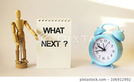 We can help, text on white notepad. Near wooden doll and alarm clock on white background We can help, text on white notepad. Near wooden doll and alarm clock on white background 106912992