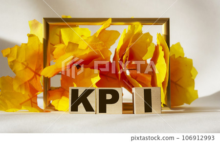 KPI text on a yellow background on wooden cubes 106912993