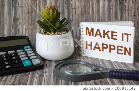 Make it possible, the phrase is written on a notebook and a wooden table. Motivational slogan. Make it possible, the phrase is written on a notebook and a wooden table. Motivational slogan. 106913142