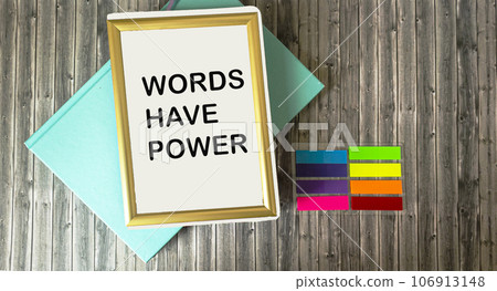 Notepad in a frame with text The words have power lying on a wooden background. 106913148