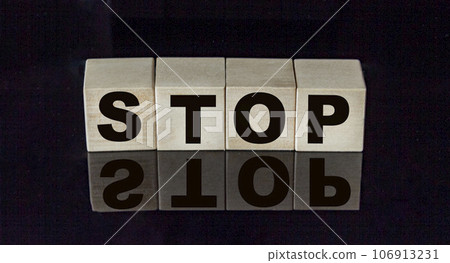 STOP text from cubes on a black mirror table STOP text from cubes on a black mirror table 106913231