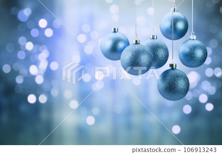 Blue trendy Christmas hanging decorations on blue background 106913243