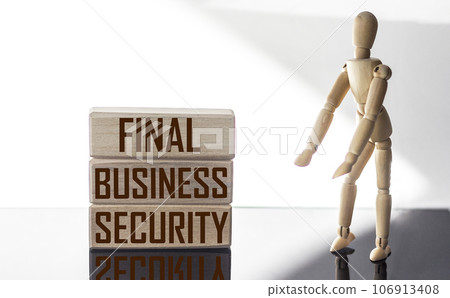text FINAL BUSINESS SECURITY. The text is written on wooden blocks, on a white and black background 106913408