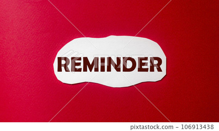 Reminder, text is written on a piece of paper and a red background. Do not forget 106913438
