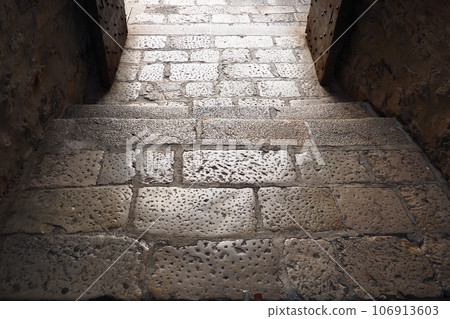 Traditional Paving stone artwork in Herceg Novi Montenegro on roads as well as sidewalks, especially in the old part of town. An old pavement paved with large rectangular stones. Pedestrian zone 106913603