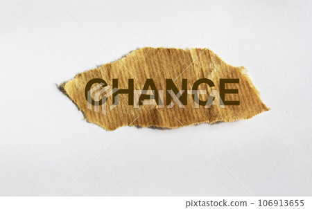 The word CHANCE is written on a piece of brown paper and against a white background. The word CHANCE is written on a piece of brown paper and against a white background. 106913655