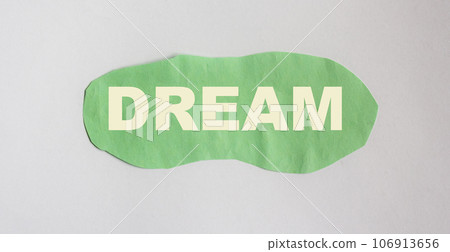 Dream, word written on green scrap of paper and blue background 106913656