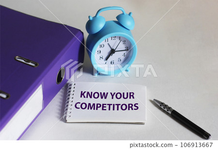 The text Know Your Competitors is written on a notebook and a white background. The text Know Your Competitors is written on a notebook and a white background. 106913667