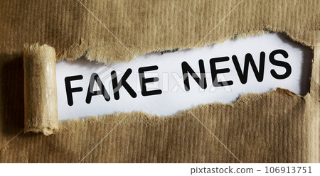 FAKE NEWS word written under torn paper. 106913751