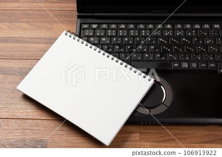 Laptop and white sketchbook Laptop and white sketchbook 106913922