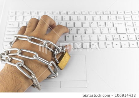 Chained hands and laptop keyboard. image of addiction 106914438