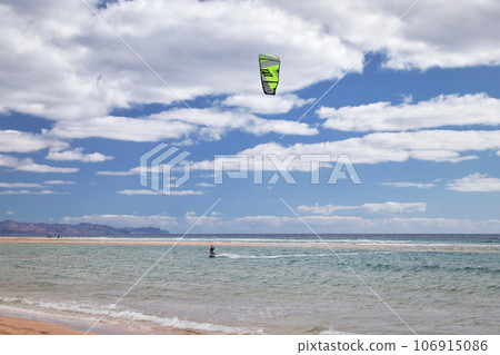 Kitesurfer in the water in a bay Risco del Paso of Fuerteventura in the Canary Islands Kitesurfer in the water in a bay Risco del Paso of Fuerteventura in the Canary Islands 106915086