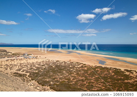 View over a wide beautiful bathing bay on the Canary Island Fuerteventura in the Atlantic Ocean View over a wide beautiful bathing bay on the Canary Island Fuerteventura in the Atlantic Ocean 106915093