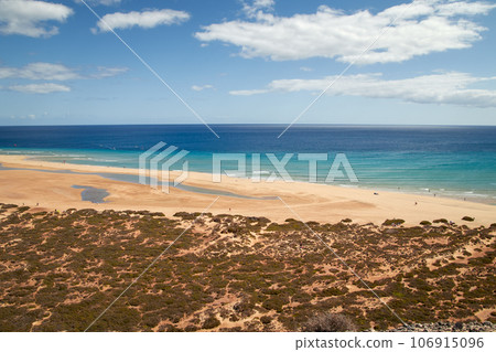 View over the wide beautiful bathing bay called Risco del Paso on the Spanish Canary Island Fuerteventura in the Atlantic Ocean 106915096