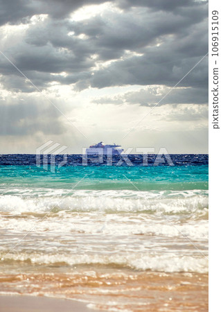 Cruise ship under dramatic sun clouds mix on the sea of atlantic ocean Cruise ship under dramatic sun clouds mix on the sea of atlantic ocean 106915109