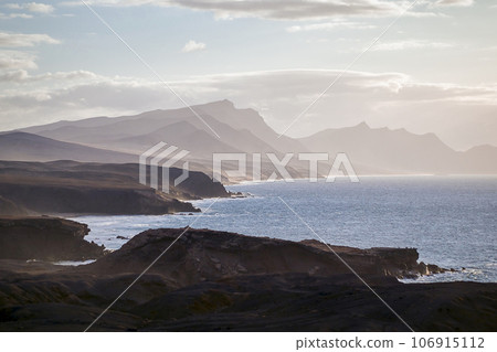 The west coast of Fuerteventura in the light fog as seen from the village of La Pared, Canary Islands, Spain The west coast of Fuerteventura in the light fog as seen from the village of La Pared, Canary Islands, Spain 106915112