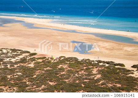 Top view of the large wide sandy bay of Risco del Paso on the Spanish island of Fuerteventura Top view of the large wide sandy bay of Risco del Paso on the Spanish island of Fuerteventura 106915141
