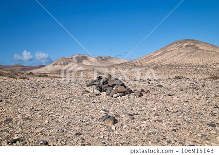 typical cairn marking and landscape in the interior of the Canary Island of Fuerteventura 106915143