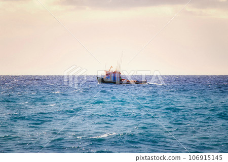 a small fishing boat in the open water on the atlantic ocean 106915145