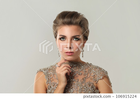 Elegant beautiful woman jewelry model wearing diamond earring on white, fashion beauty portrait 106915224