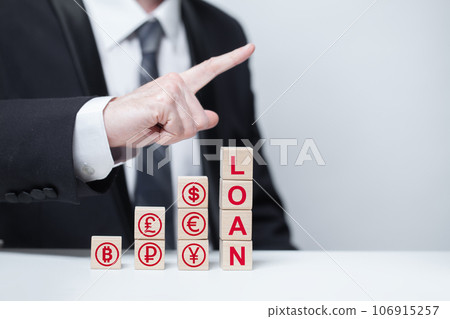 Wooden cubes with word red loan and currency icons, businessman point up, business loans Wooden cubes with word red loan and currency icons, businessman point up, business loans 106915257