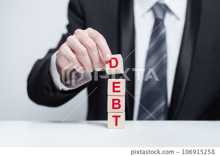 Wooden blocks with word debt. Business loan, credit, mortgage concept Wooden blocks with word debt. Business loan, credit, mortgage concept 106915258