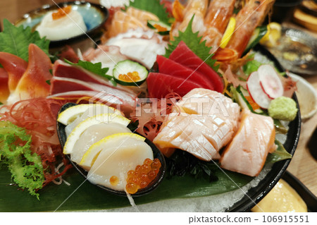fresh sashimi combo on dish in Japanese restaurant fresh sashimi combo on dish in Japanese restaurant 106915551