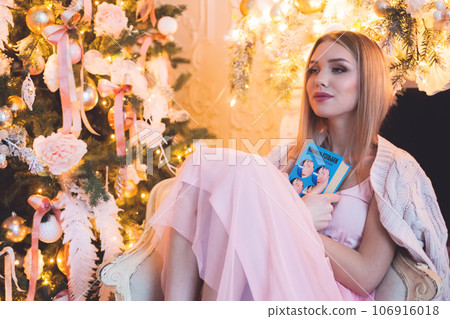 Woman at home. Christmas and New Year holidays concept Woman at home. Christmas and New Year holidays concept 106916018