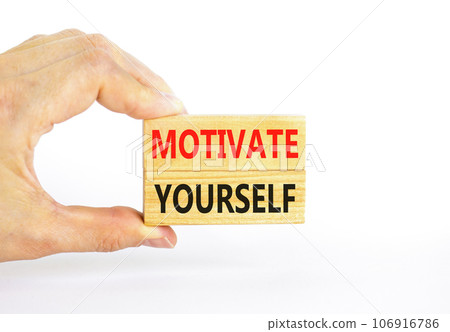 Motivate yourself symbol. Concept words Motivate yourself on beautiful wooden blocks. Beautiful white background. Businessman hand. Business psychology motivate yourself concept. Copy space. 106916786