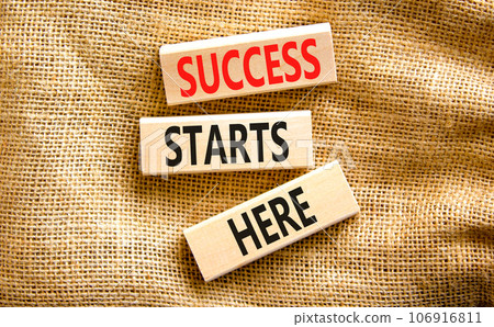 Success starts here symbol. Concept word Success starts here on beautiful wooden block. Beautiful canvas table canvas background. Business motivational success starts here concept. Copy space. 106916811