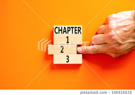 Time to chapter 2 symbol. Concept word Chapter 1 2 3 on wooden block. Businessman hand. Beautiful orange table orange background. Business planning and time to chapter 2 concept. Copy space. Time to chapter 2 symbol. Concept word Chapter 1 2 3 on wooden block. Businessman hand. Beautiful orange table orange background. Business planning and time to chapter 2 concept. Copy space. 106916838