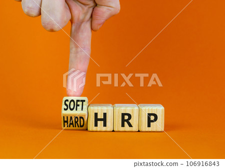 HRP, human resource planning symbol. Businessman turns a wooden cube and changes words hard HRP to soft HRP. Beautiful orange background. Business, HRP, human resource planning concept. Copy space. HRP, human resource planning symbol. Businessman turns a wooden cube and changes words hard HRP to soft HRP. Beautiful orange background. Business, HRP, human resource planning concept. Copy space. 106916843