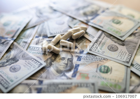 Pills on the background of the dollar close-up. Pills on the background of the dollar close-up. 106917007
