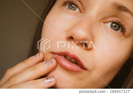 Beautiful young woman portrait Thoughtful enigmatic girl with gray eyes looking. Beautiful young woman portrait Thoughtful enigmatic girl with gray eyes looking. 106917127