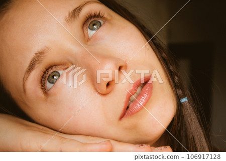 Beautiful woman portrait, thoughtful enigmatic girl with gray eyes looking up Beautiful woman portrait, thoughtful enigmatic girl with gray eyes looking up 106917128