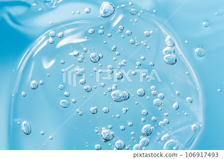 Close up macro Aloe vera gel serum cosmetic texture blue background with bubbles. Cruelty free. Lemongrass gel skincare product. antibacterial liquid with aloe vera, moisturizing. Close up macro Aloe vera gel serum cosmetic texture blue background with bubbles. Cruelty free. Lemongrass gel skincare product. antibacterial liquid with aloe vera, moisturizing. 106917493